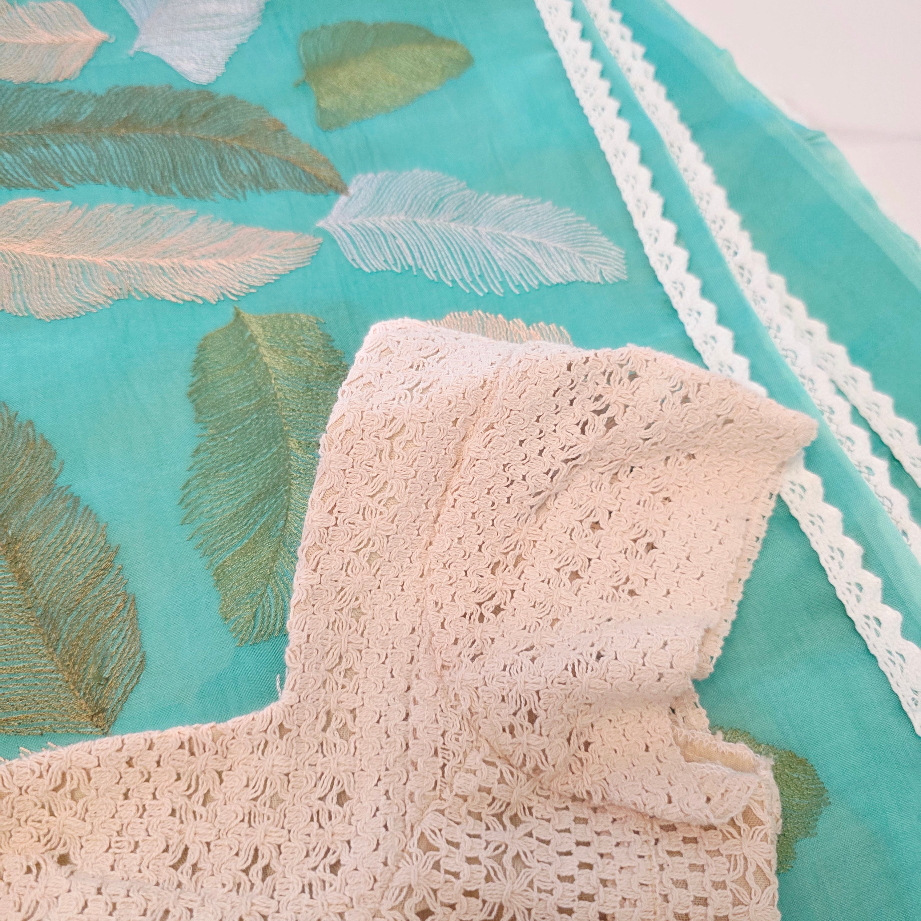 Teal blue organza saree with leaf embroidery