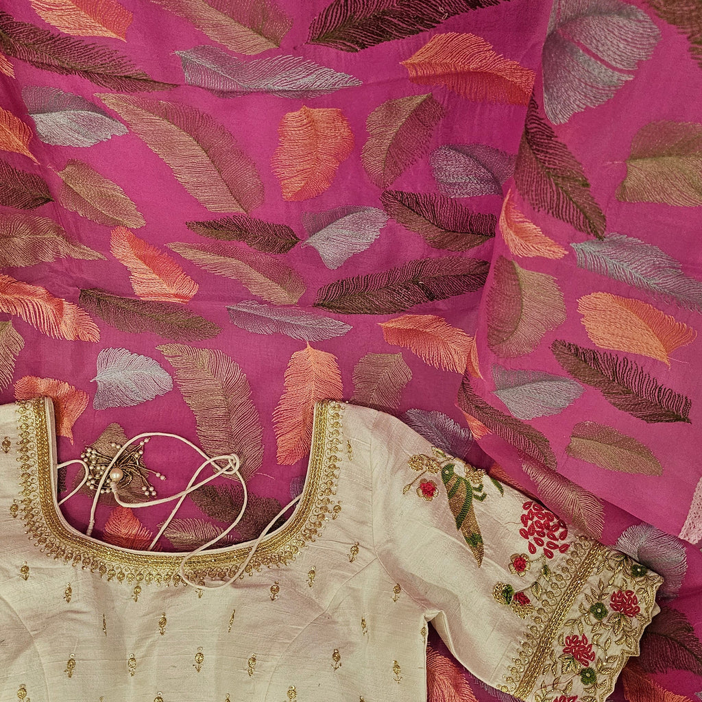 Embroidered blouse with pink saree with leaf pattern