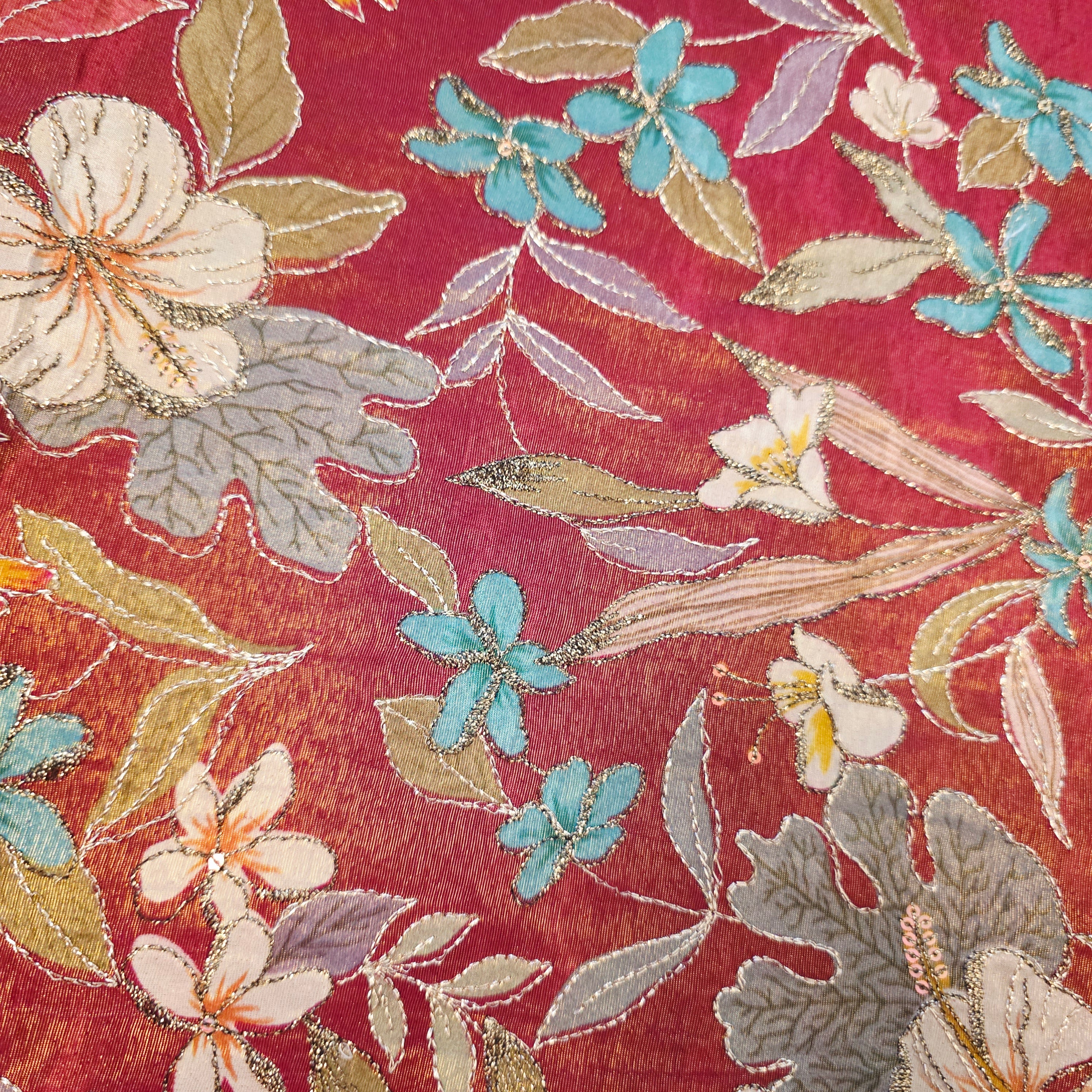 Maroon Tissue Saree with allover floral sequins paired with designer blouse