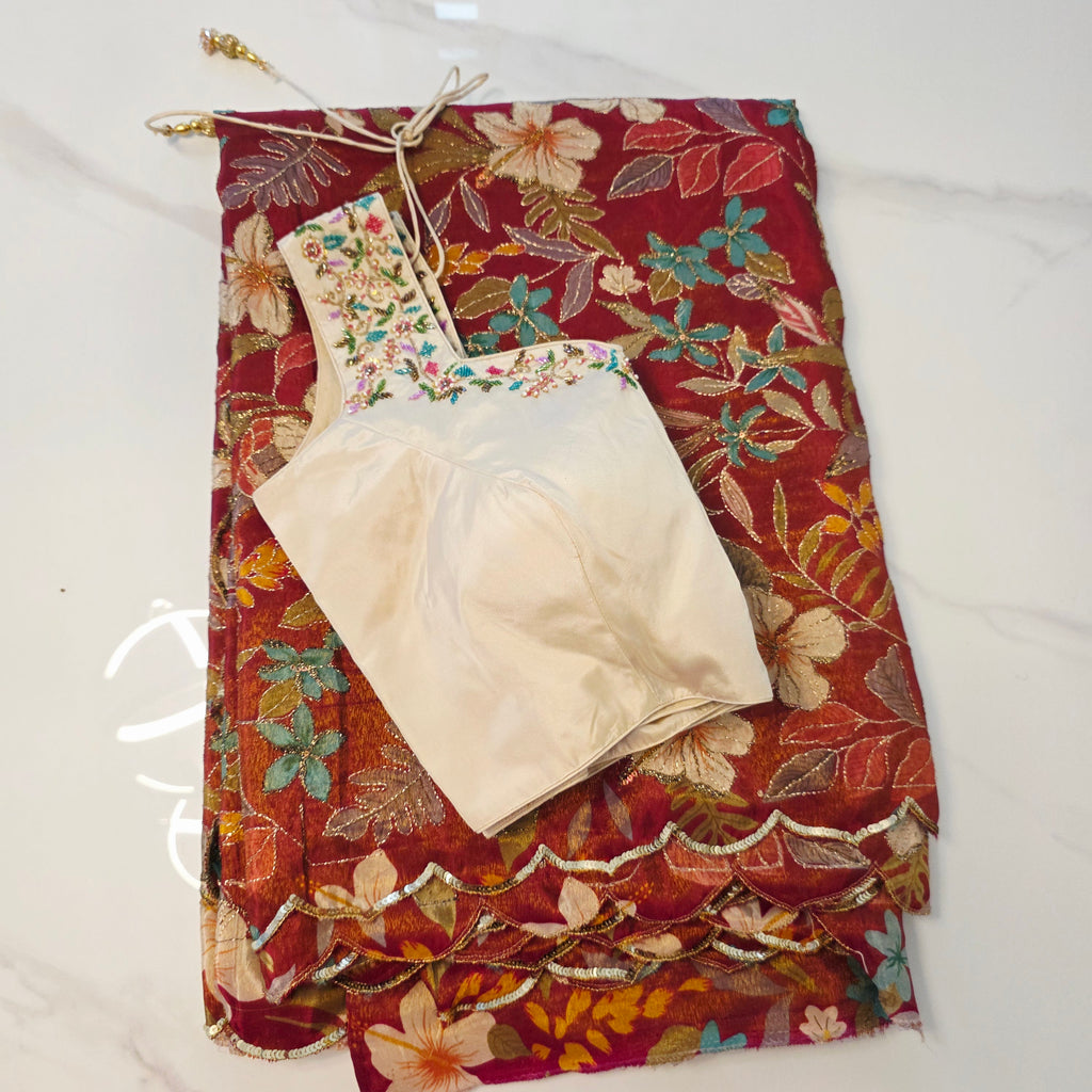 Maroon Tissue Saree with allover floral sequins paired with designer blouse