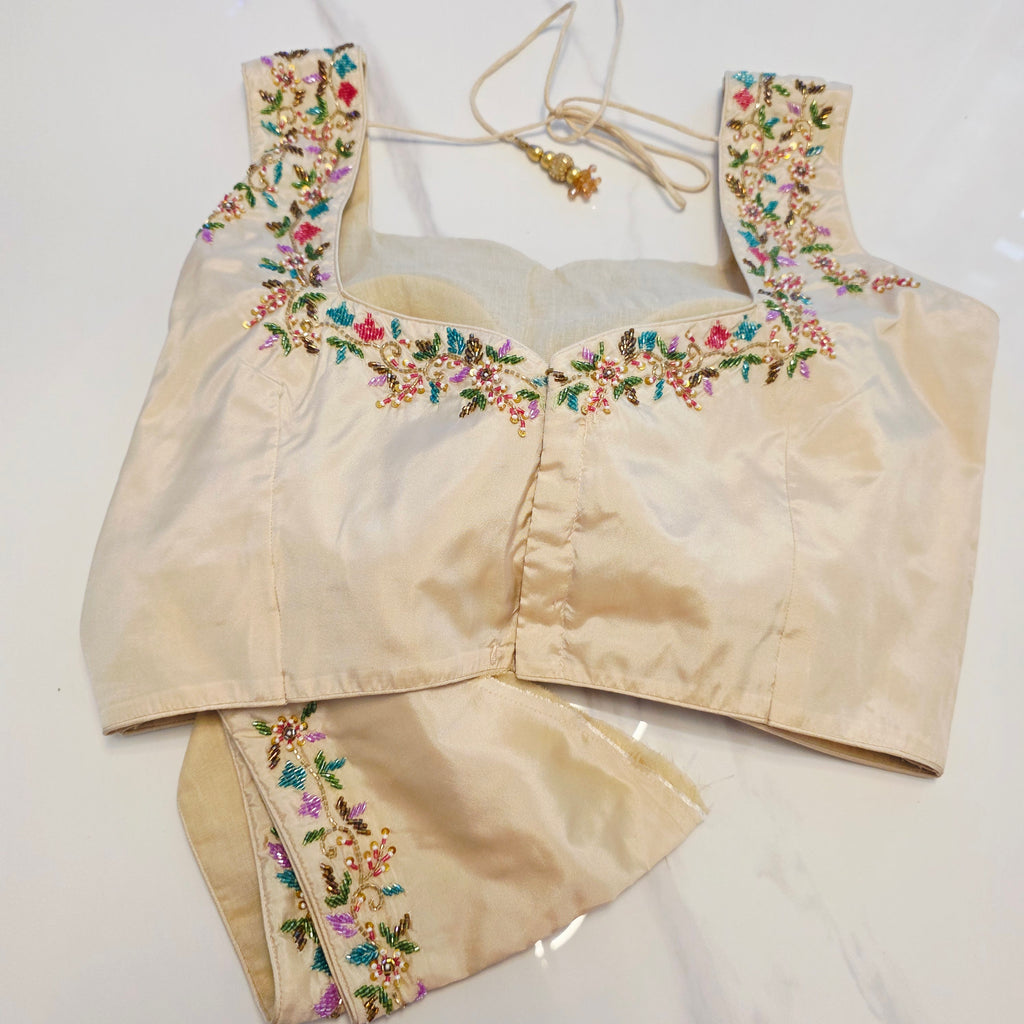 Maroon Tissue Saree with allover floral sequins paired with designer blouse