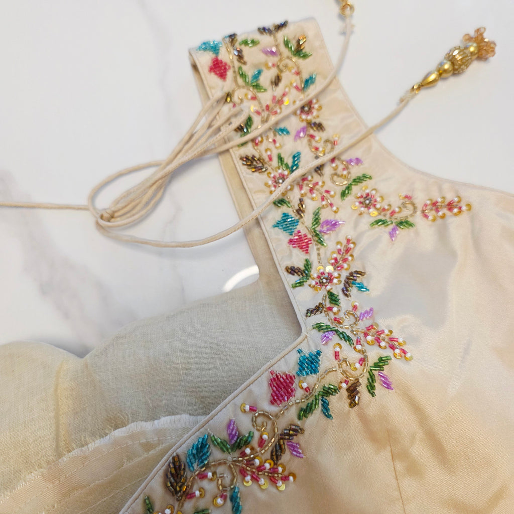 Maroon Tissue Saree with allover floral sequins paired with designer blouse