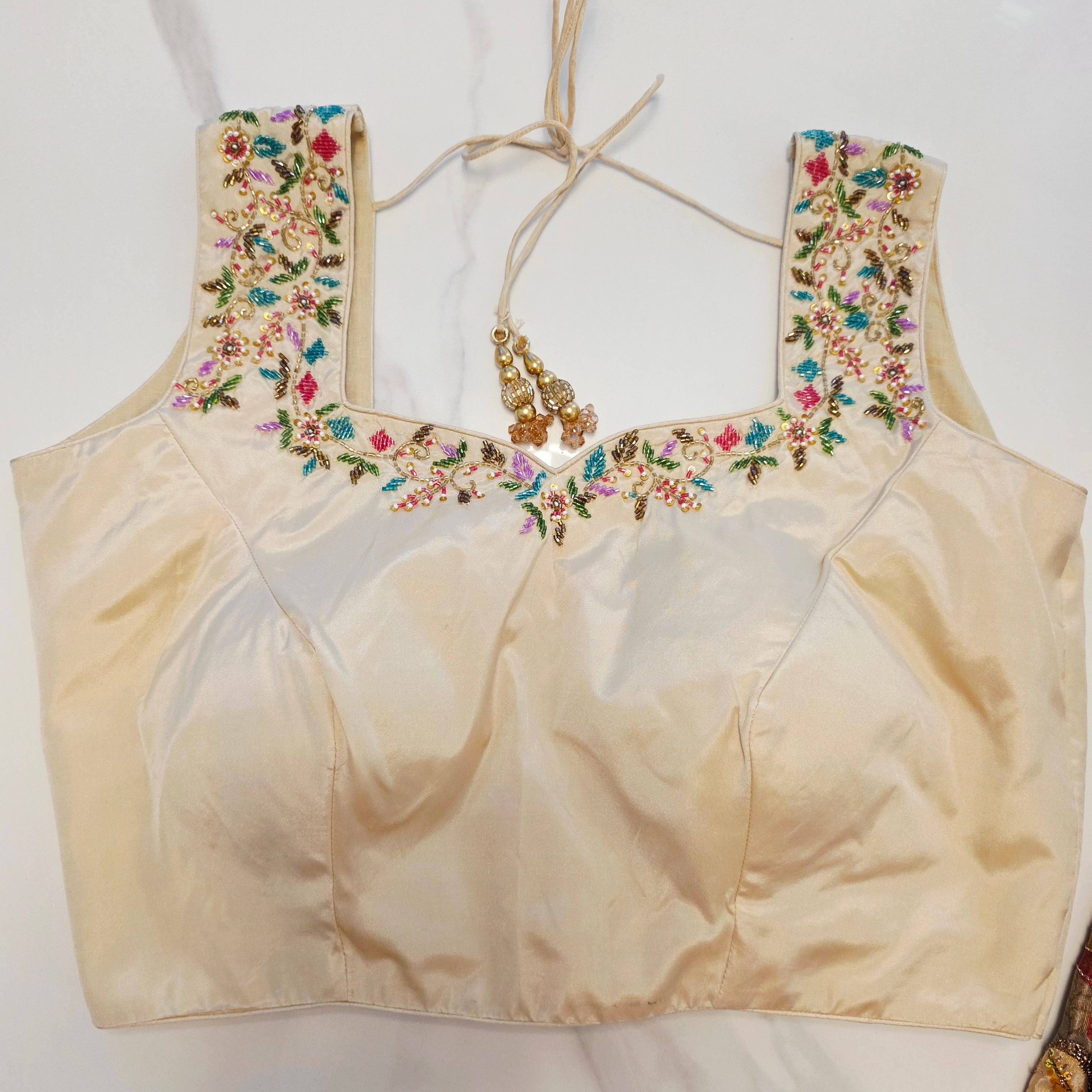 Maroon Tissue Saree with allover floral sequins paired with designer blouse