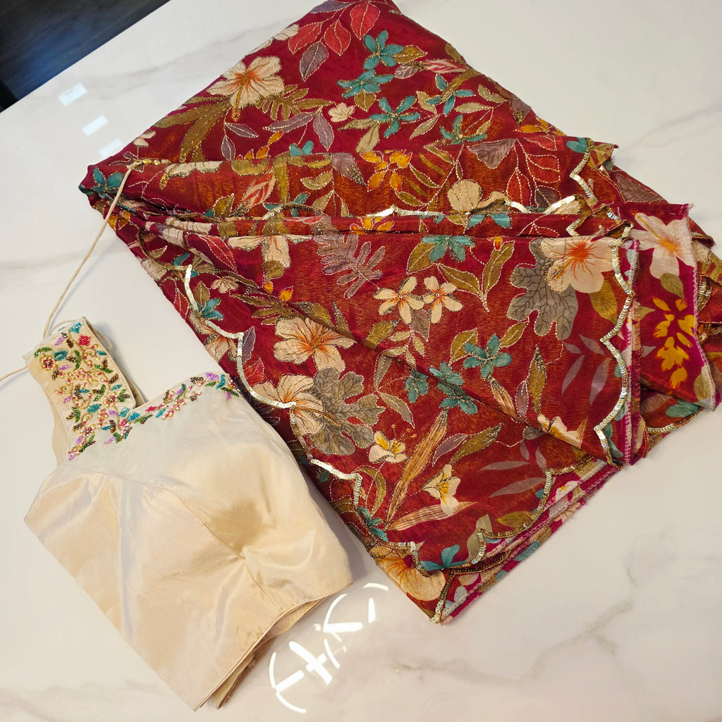 Maroon Tissue Saree with allover floral sequins paired with designer blouse