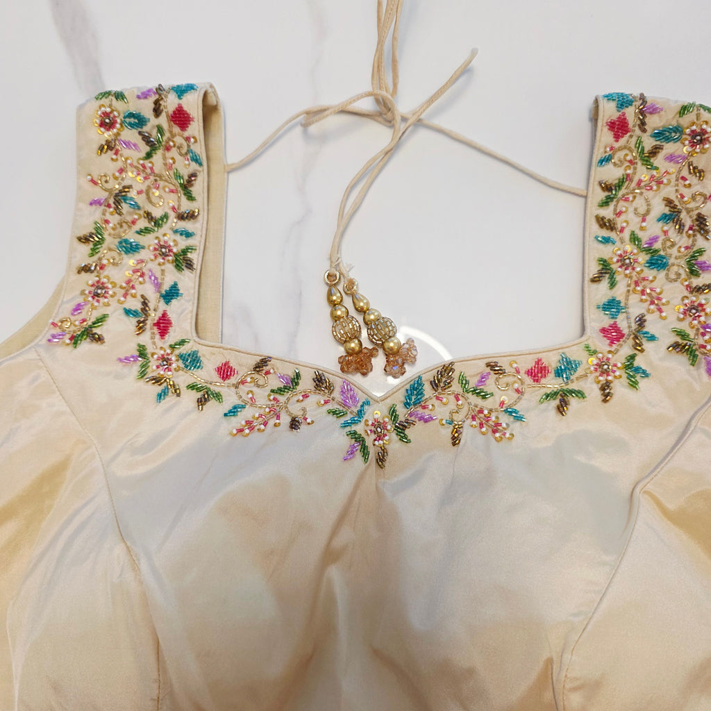 Maroon Tissue Saree with allover floral sequins paired with designer blouse