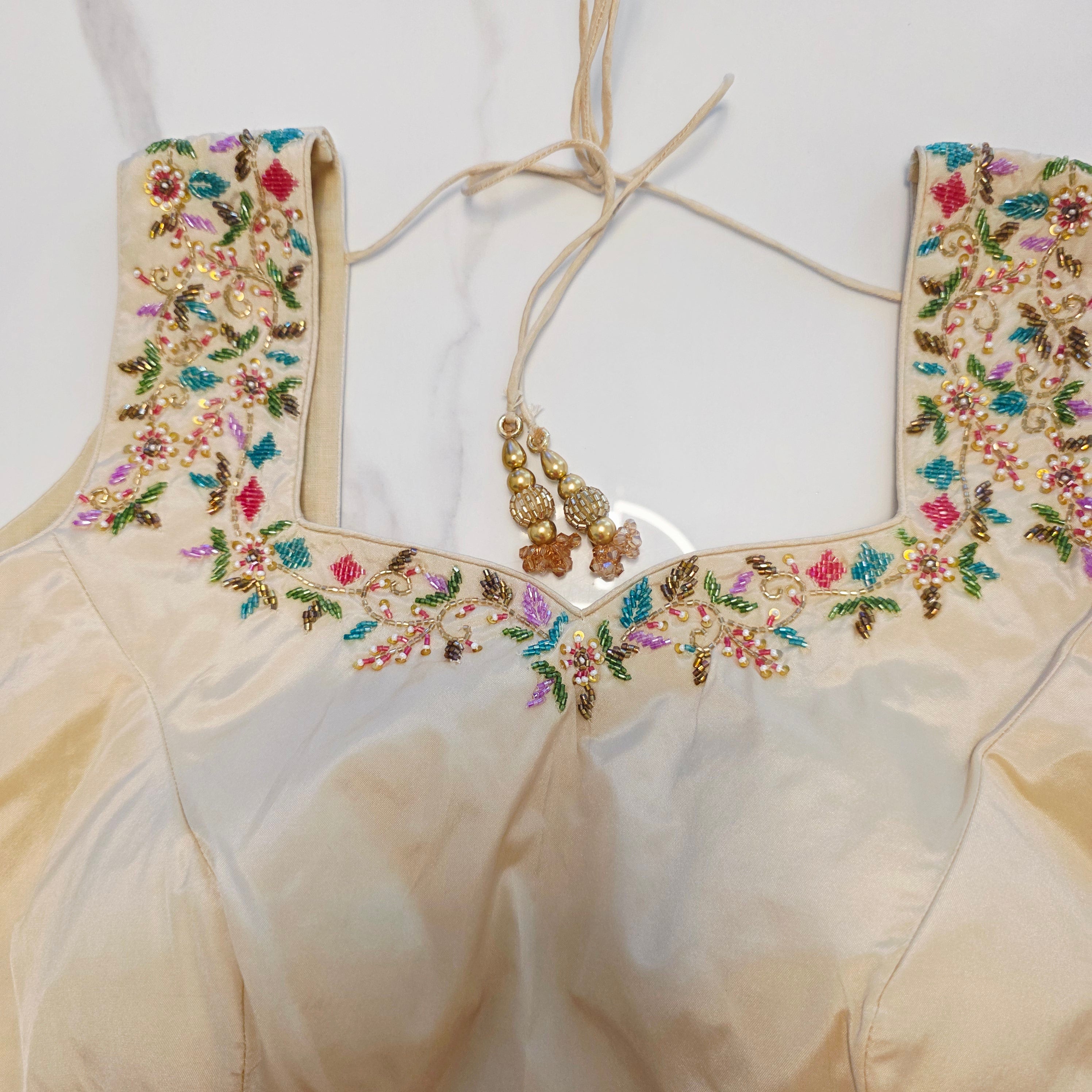 Maroon Tissue Saree with allover floral sequins paired with designer blouse