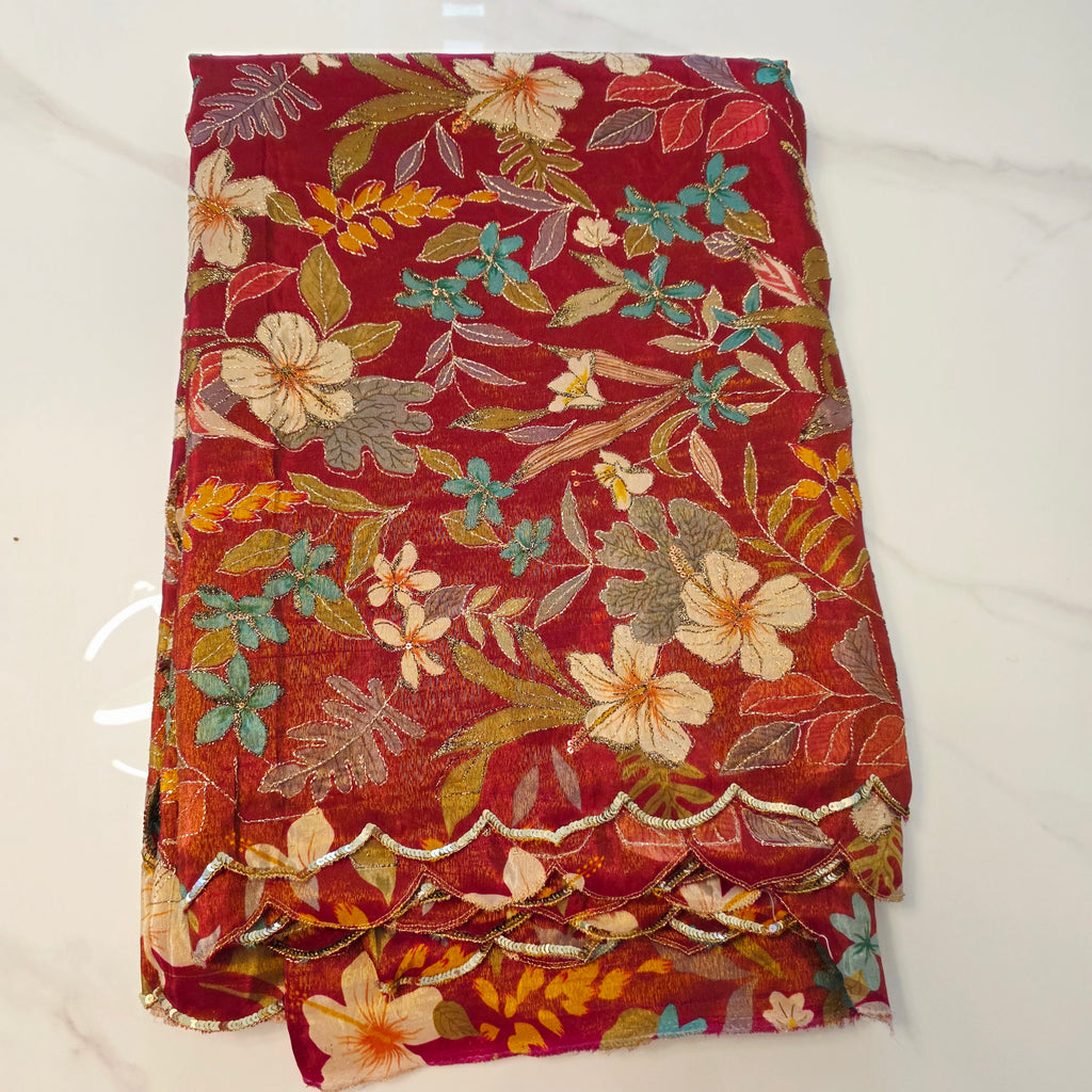 Maroon Tissue Saree with allover floral sequins paired with designer blouse