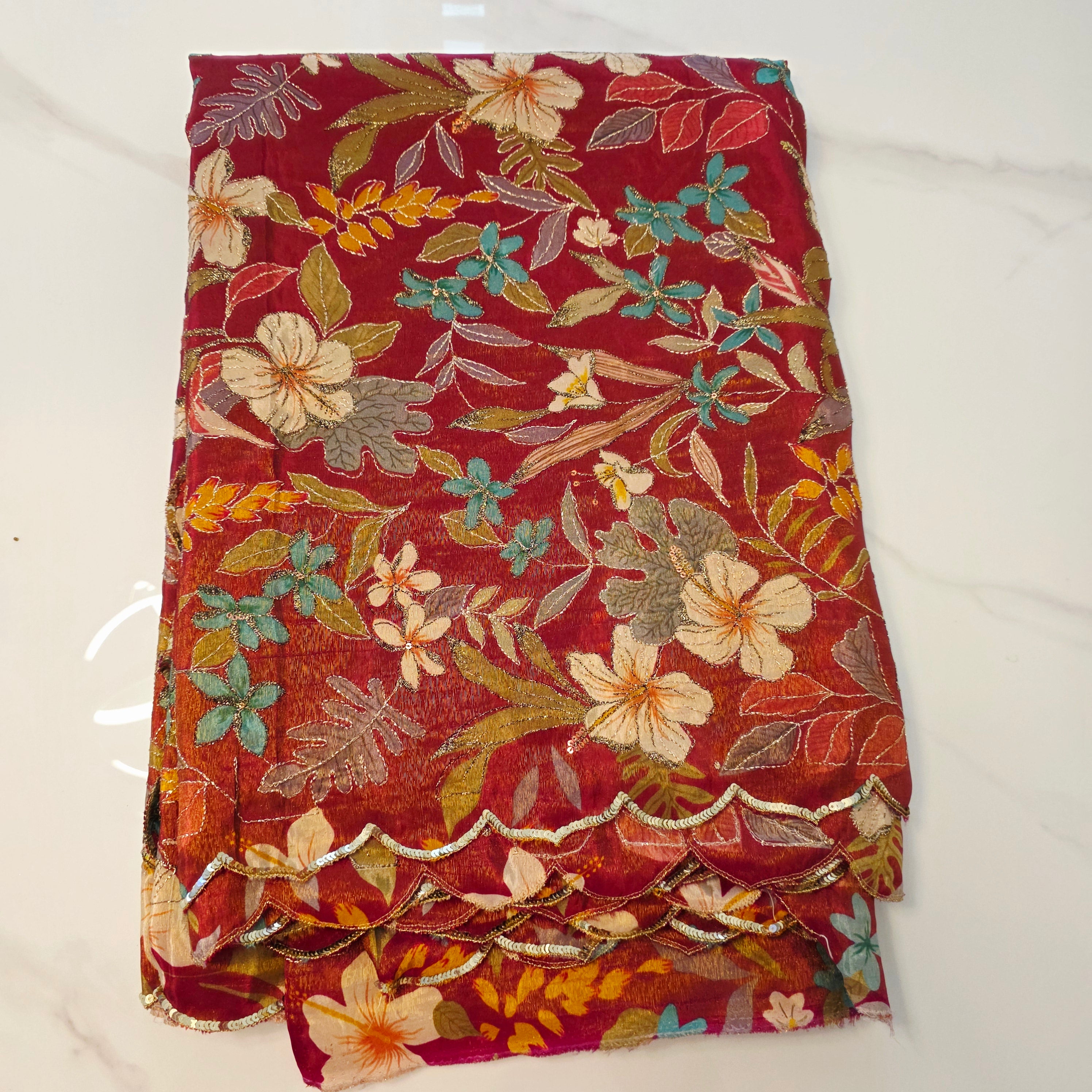 Maroon Tissue Saree with allover floral sequins paired with designer blouse