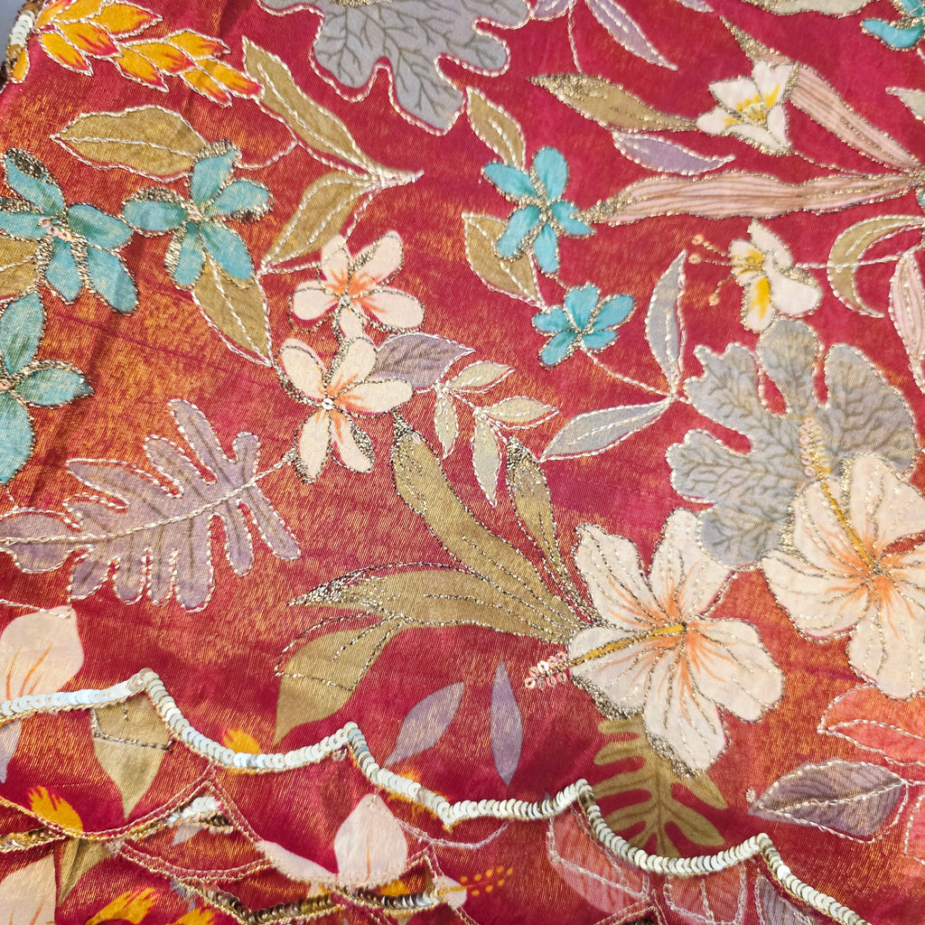 Maroon Tissue Saree with allover floral sequins paired with designer blouse