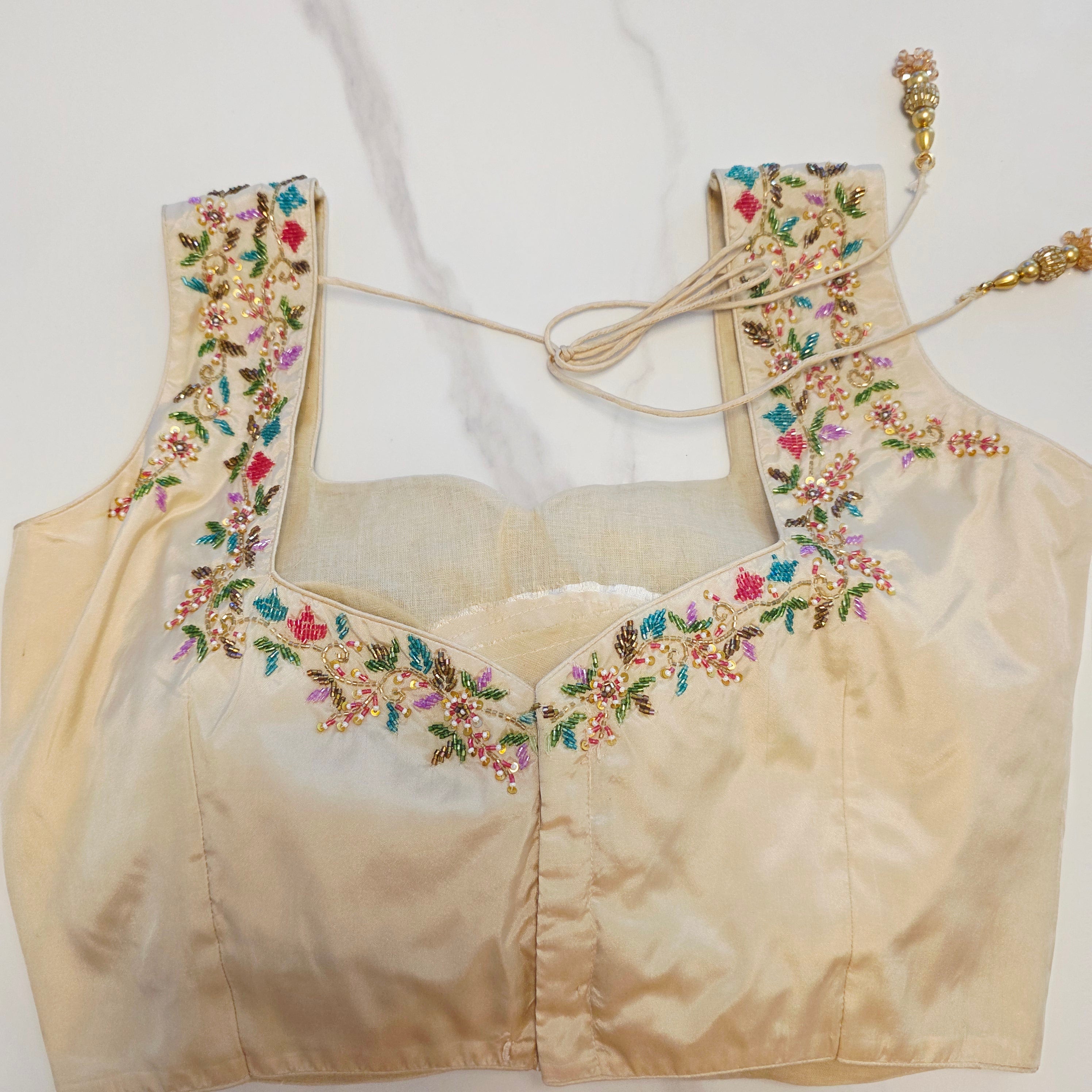 Maroon Tissue Saree with allover floral sequins paired with designer blouse